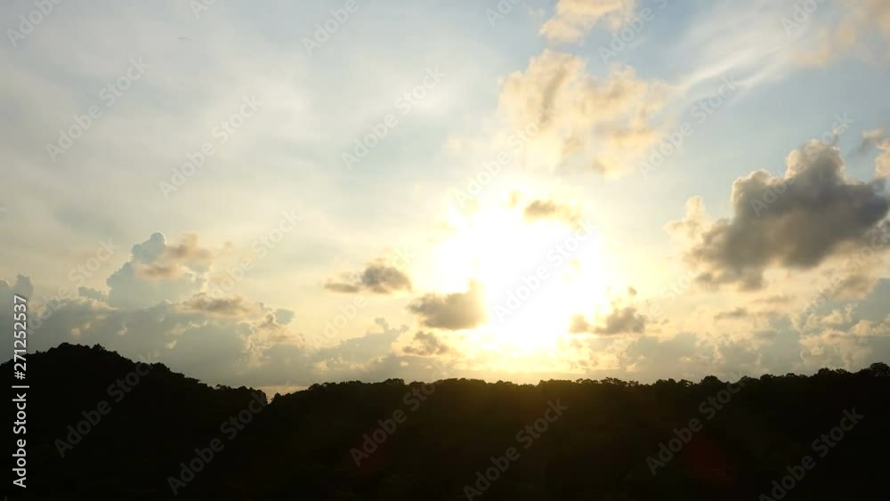 Clouds rolling past golden sun in the last hours of the day Rayong, Thailand