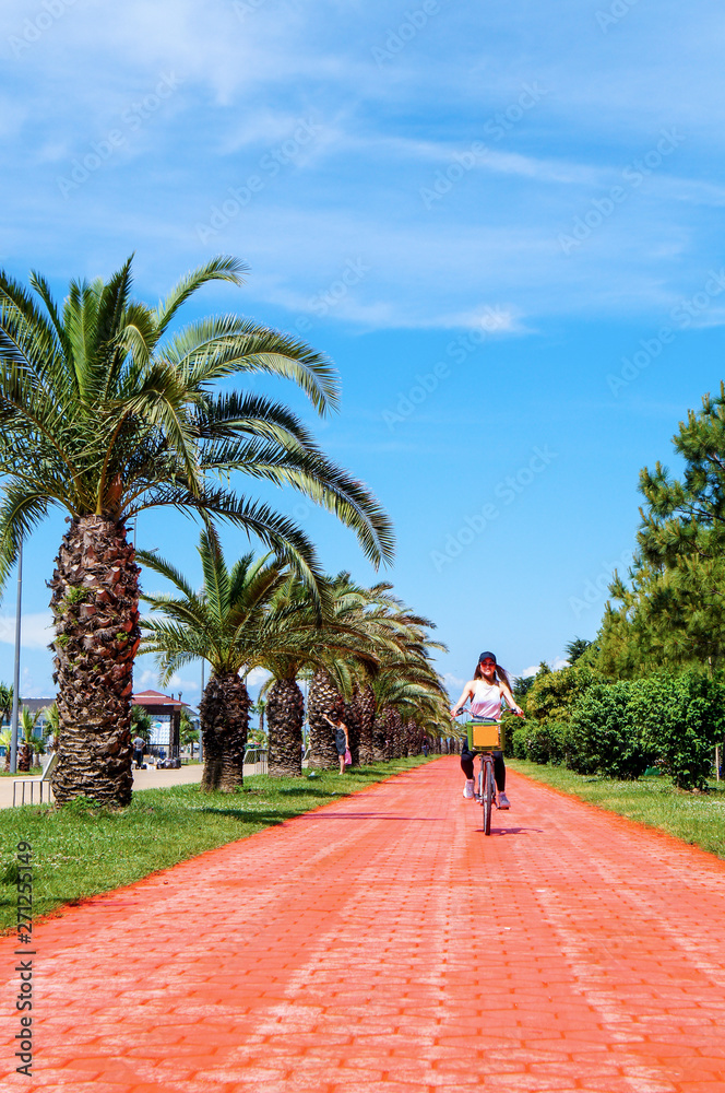Fototapeta premium Girl on Bike with Palms in Batumi Cycle Patch