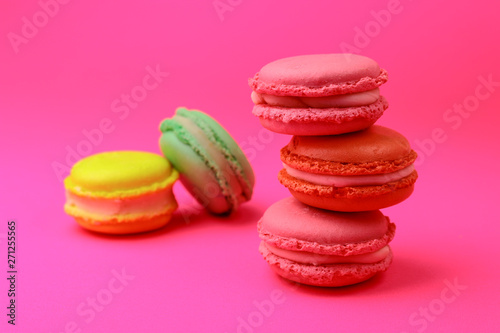 colorful macaroons stack on pink background.