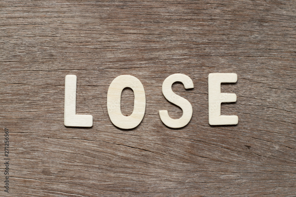 Alphabet letter in word lose on wood background Alphabet letter in word lose on wood background