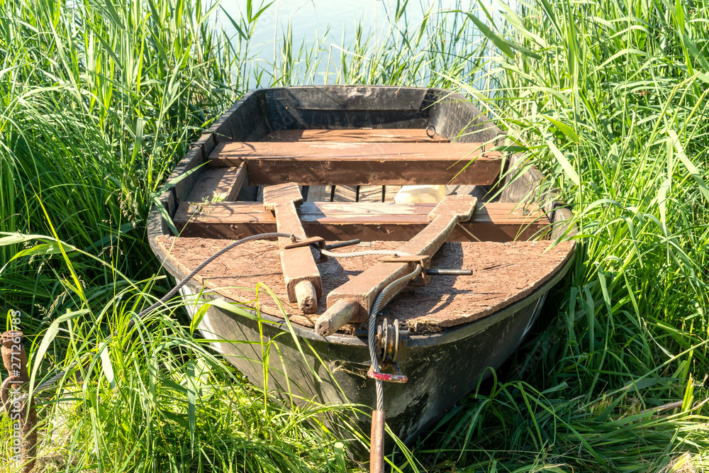 Old wooden boat on the lake bank Old wooden boat on the lake bank
