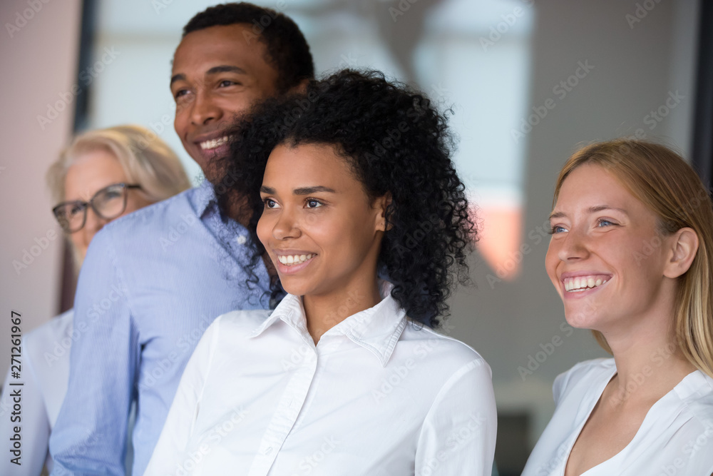 Diverse employees with African American leader posing in office Diverse employees with African American leader posing in office