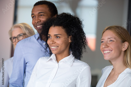 Diverse employees with African American leader posing in office