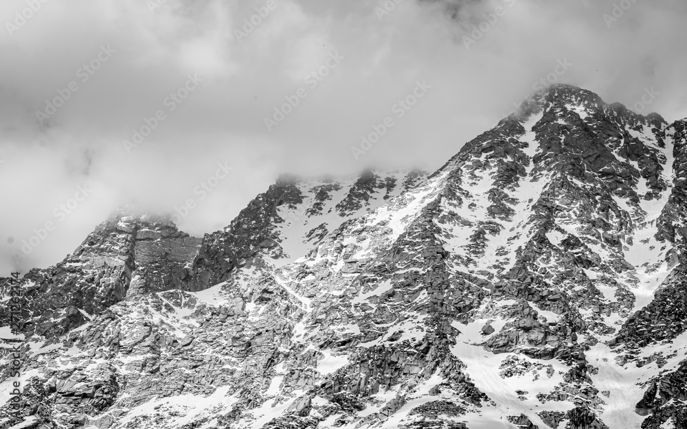 black and white photo of mountains in winter