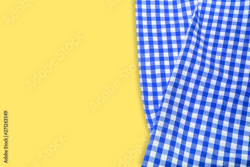 Blue checkered napkin on a yellow background.