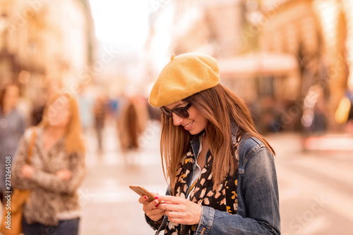 A woman using her smartphone in the pedestrian zone photo
