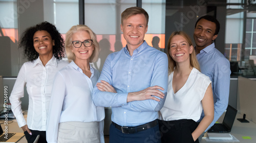Billede på lærred Successful team leader and diverse employees posing for photo together