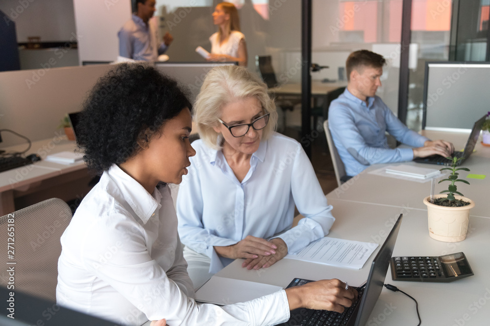 Fototapeta premium African American businesswoman with mature employee working together