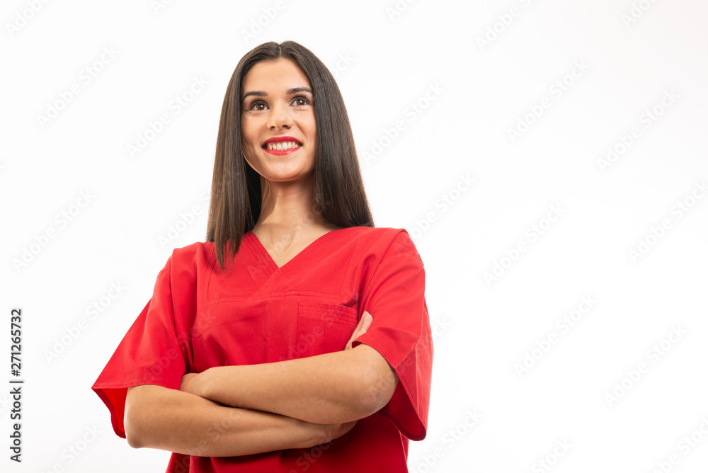 Low angle of nurse wearing scrubs standing with arms crossed