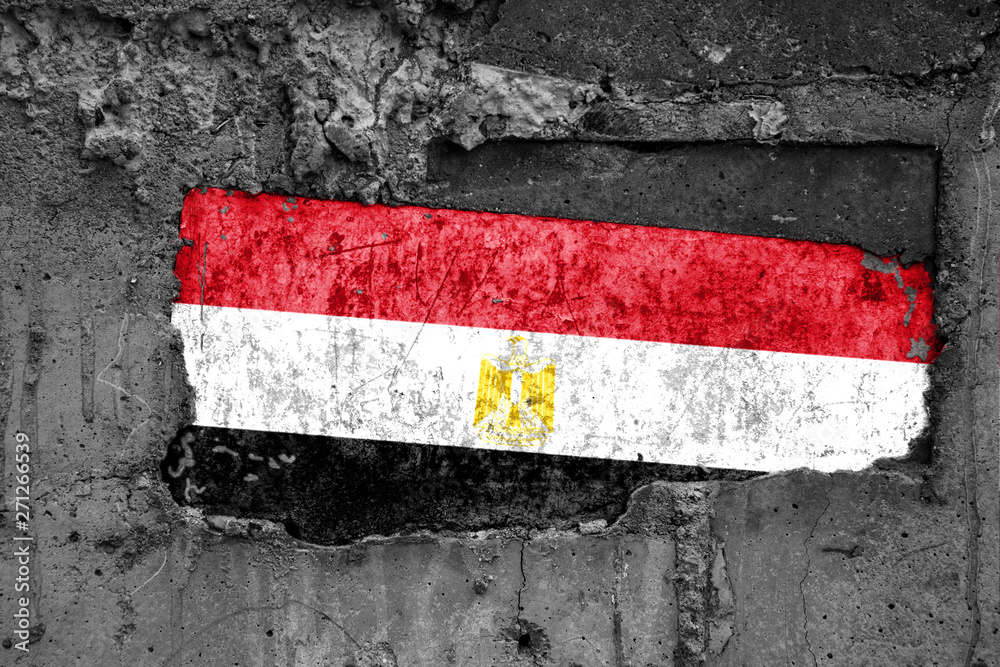 The flag of Egypt on a dirty wooden surface, built into a concrete base, with scuffs and scratches. Loss or destruction conception.