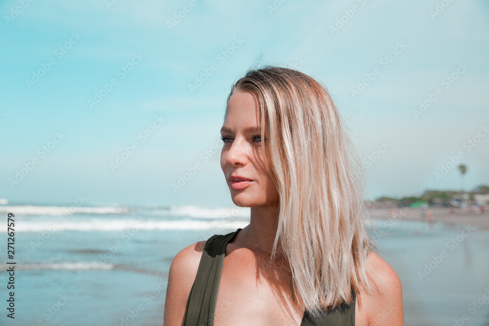 Portrait of beautiful woman in summer on tropical beach closed to ocean.