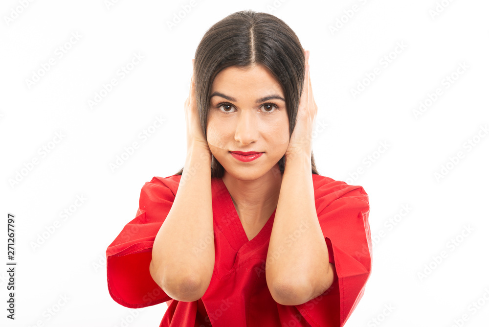 Portrait of nurse wearing scrubs covering ears like deaf concept Portrait of nurse wearing scrubs covering ears like deaf concept