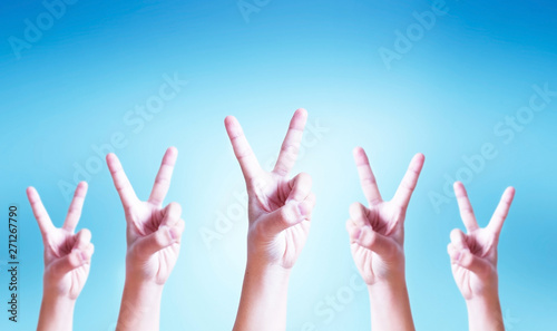 International Day of Cooperatives concept: human hands showing v-sign