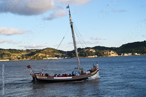 a traditional boat sailing along Tago river in Lisbon  Portugal