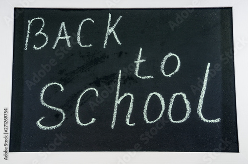 inscription in chalk  back to school  on a blackboard