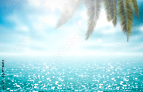 Blurred background of sea and green palm 