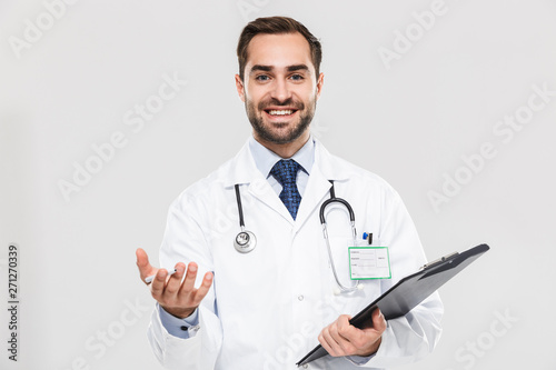 Portrait of happy young medical doctor smiling at camera and holding health card