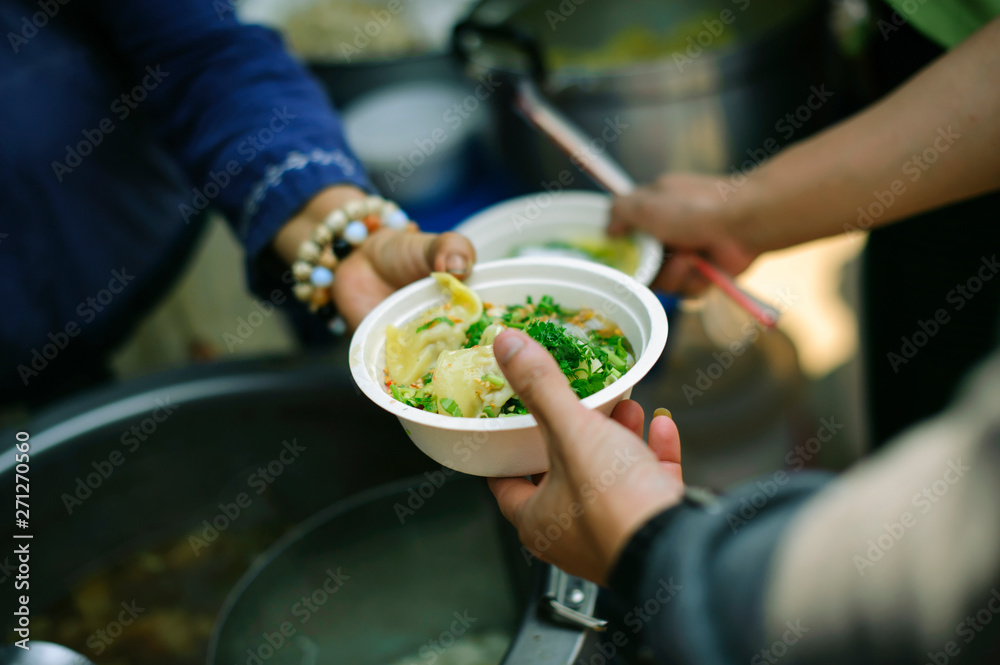Concept of Feeding : Volunteers give food to the poor : donating food is helping human friends in society : Helping People With Hunger With Kindness : the concept of life problems, hunger in society Concept of Feeding : Volunteers give food to the poor : donating food is helping human friends in society : Helping People With Hunger With Kindness : the concept of life problems, hunger in society
