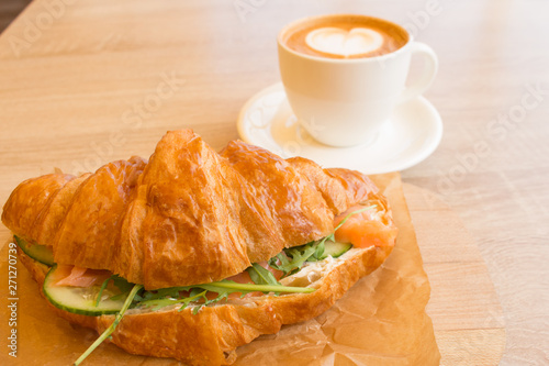 Cappuccino and croissant with a complex filling, Breakfast, lunch photo