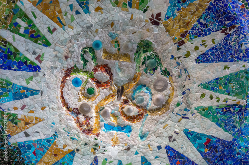 Detail of the famous broken tiles (trencadis) in the Park Güell, Barcelona, Spain.