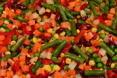 Sliced vegetables  corn  beans  peas  carrots  sweet peppers background.