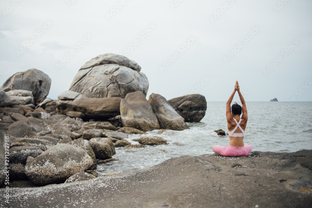 Asian girl practice Yoga on the beach Sunrise morning day