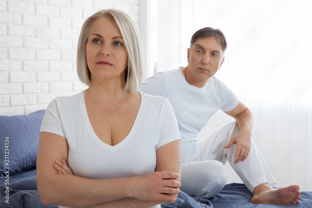 Offended woman and man trying to reconcile in bed