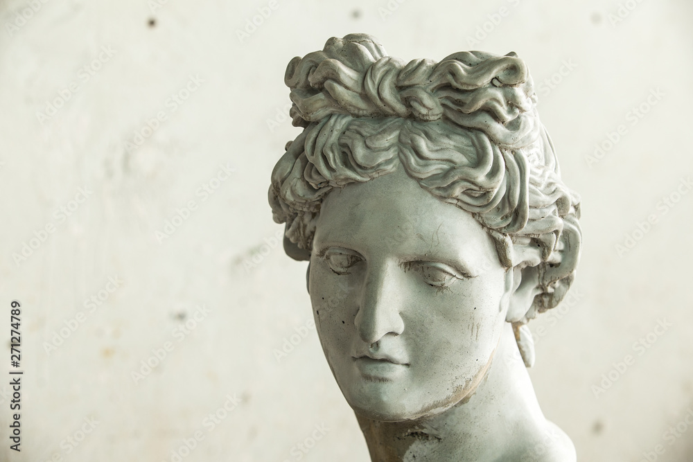 Gypsum sculptures. The head of the gypsum apollo in the workshop. Gypsum sculptures. The head of the gypsum apollo in the workshop.