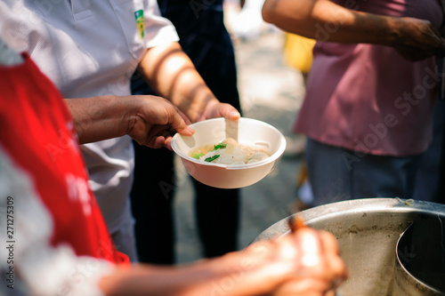 Hand begging for food from the rich's share : The beggar is waiting for food from charity aid : the concept of begging and hunger : Hunger problems of the poor have been donated food to reduce hunger