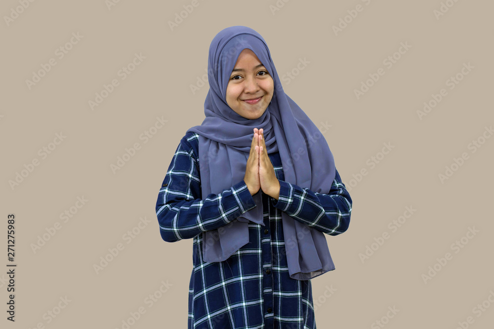 portrait of beautiful Muslim hijab woman congratulates Eid al-Fitr in front of the camera