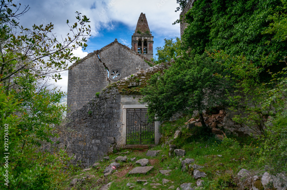 Fototapeta premium The ruins of an old abandoned Catholic church Stara Zupna Crkva on Mount Vrmac, the town of Prcanj, the Bay of Kotor, Montenegro.