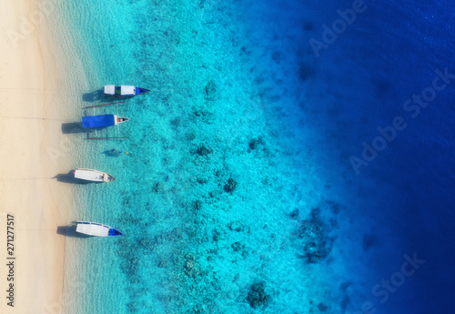 Boats on the water surface from top view. Turquoise water background from top view. Summer seascape from air. Gili Meno island, Indonesia. Travel - image photo