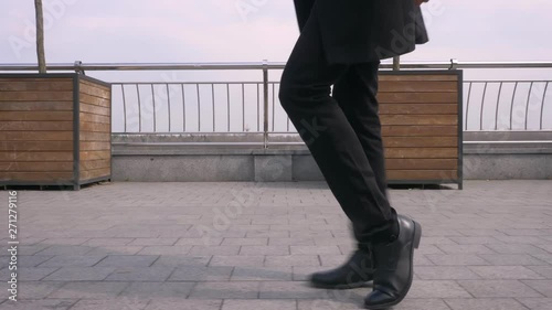 Closeup portrait of young happy attractive african american businessman performing a moonwalk on the street in the urban city photo