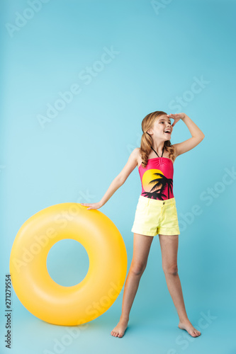 Cheerful little girl wearing swimsuit standing i