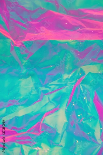 Abstract background of neon colours from crumpled gift paper and backlight © moskoviya