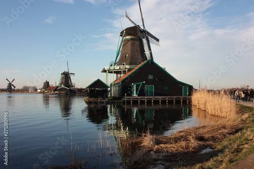 old dutch wooden windmill in zaanse schans on the water of the river Zaan