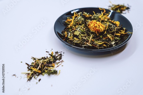 Dry tea from useful herbs and flowers on a light background