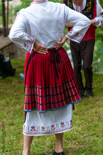 People in traditional costumes dance bulgarian