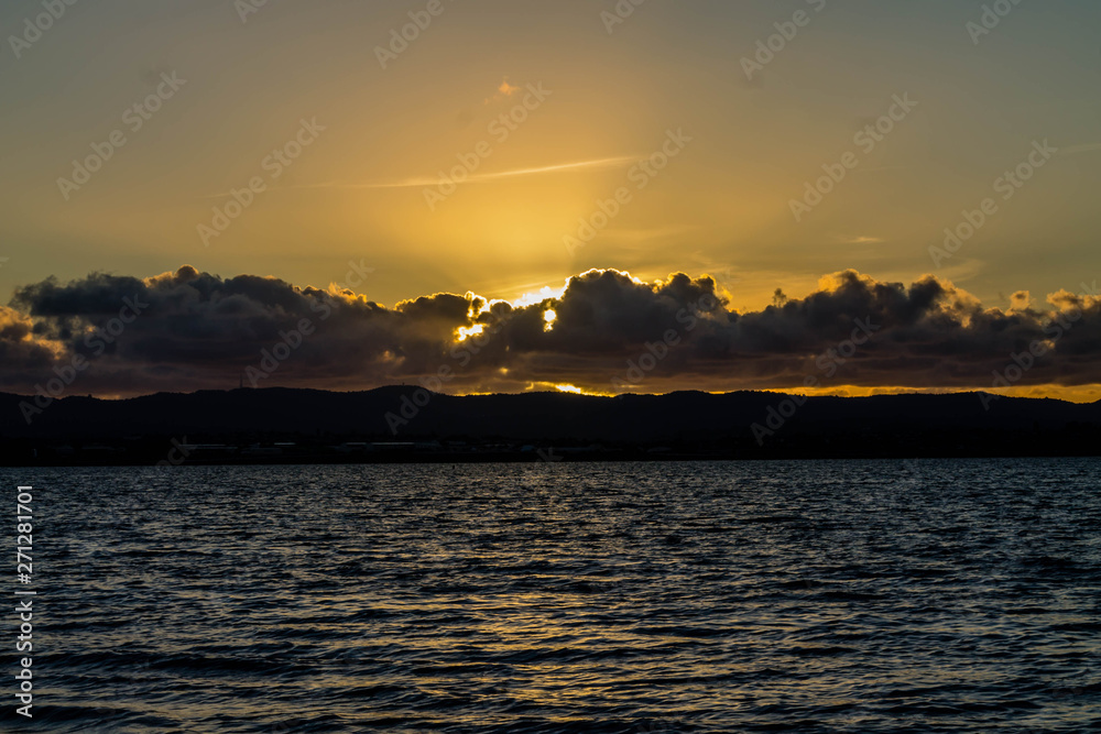 Golden sunsets are the highlight on this beach, Point Chevier, Auckland, New Zealand