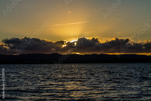 Golden sunsets are the highlight on this beach, Point Chevier, Auckland, New Zealand photo