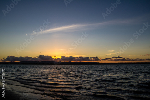 Golden sunsets are the highlight on this beach, Point Chevier, Auckland, New Zealand photo