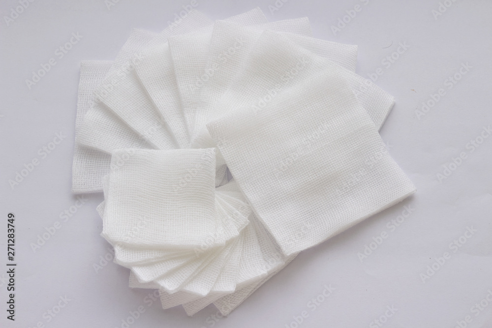 Pile of big and small size pad gauzes on white background in fan shape Pile of big and small size pad gauzes on white background in fan shape