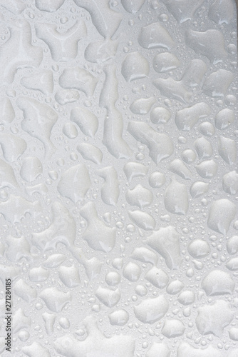 Silver liquid drops, many drops of abstract shapes on a silver b