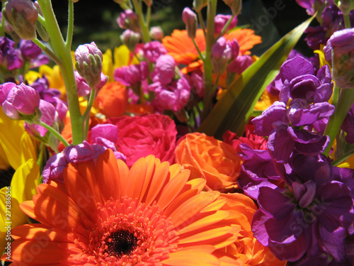 closeup of bright orange pink purple flowers in bouquet