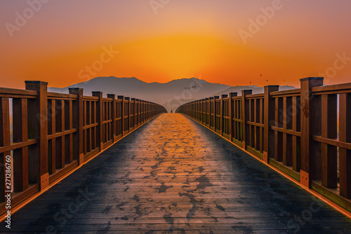 Wooden bridge Sunrise landscape at Suncheon bay Korea.