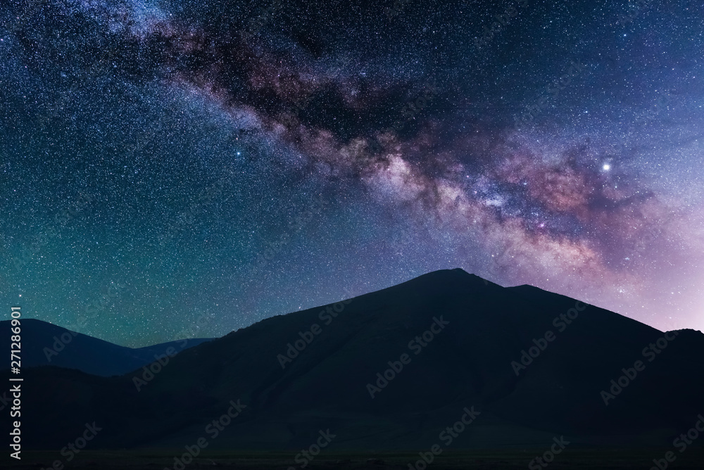 Beautiful starry sky. Milky way galaxy over the mountains. Night landscape.