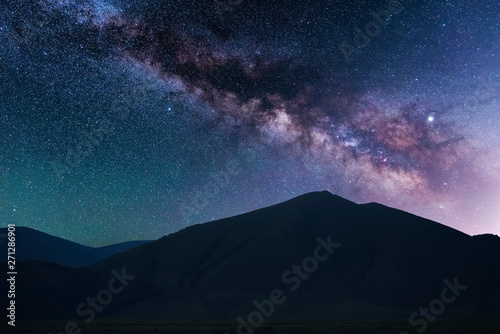 Beautiful starry sky. Milky way galaxy over the mountains. Night landscape. © Inga Av