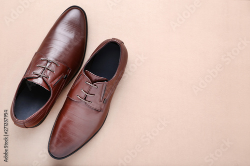 Male leather shoes on beige background
