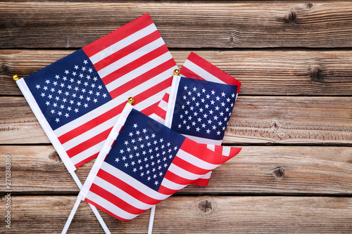 Fototapeta Naklejka Na Ścianę i Meble -  American flags on brown wooden table