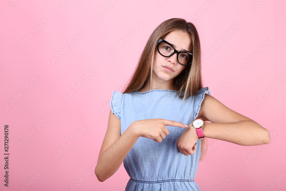 Young girl with wrist watch and glasses on pink background Young girl with wrist watch and glasses on pink background